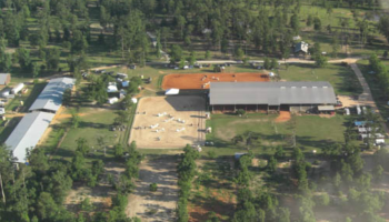 An aerial view of a horse barn and stables.